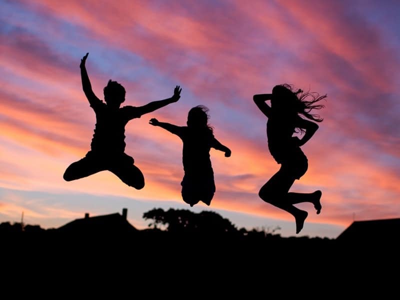 people jumping at sunset